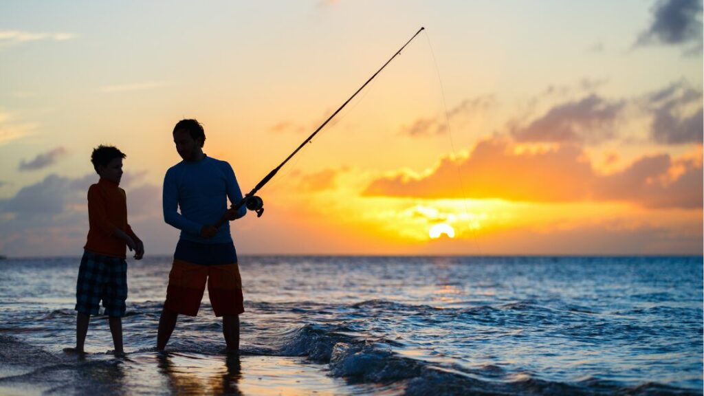 Father and son fishing on the beach